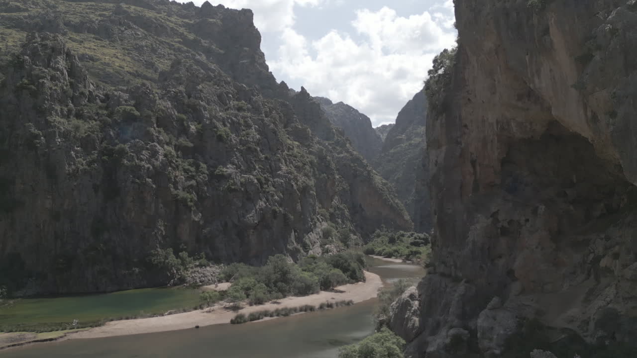 Breathtaking 4K drone footage gliding between two towering cliffs at Sa Calobra, Mallorca. This cinematic flythrough captures the dramatic rock formations, narrow canyon.