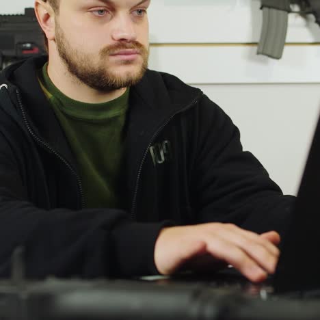 Man-behind-a-counter-in-an-arms-store-2