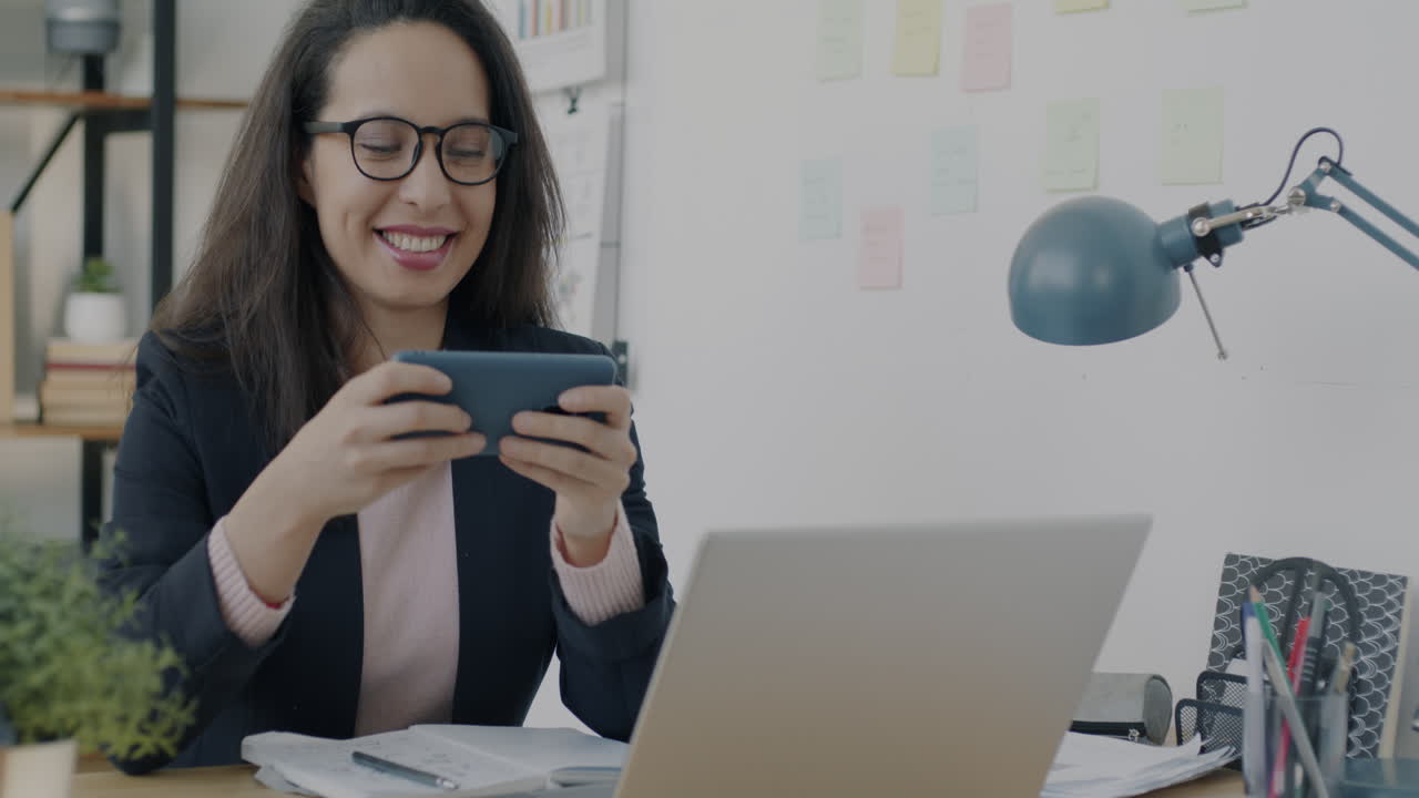 Woman using smartphone in a modern office