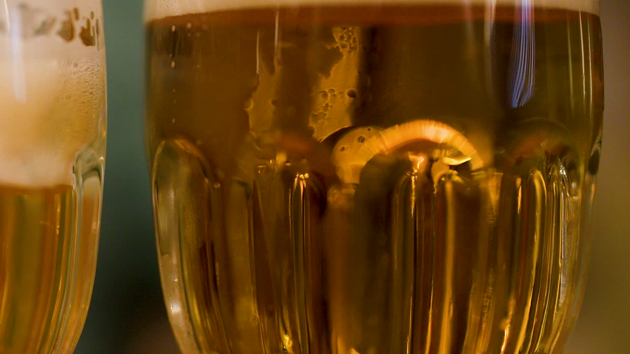 Closeup of lager mugs clinking, foam rising, symbolizing friendship and celebration in Pilsen