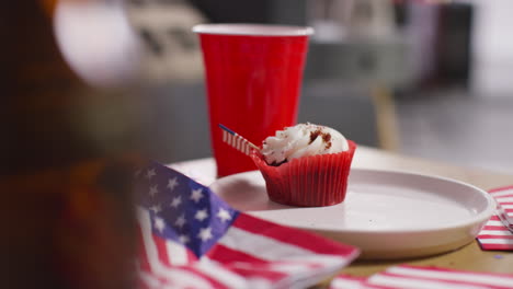 close up of cupcakes american stars and stripes flags and bottles of beer at party celebrating 4th july independence day 7