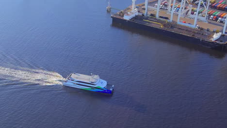 aerial view rotating above san francisco alameda ferry leaving oakland shipping port estuary