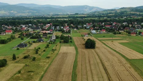 Aerial-view-of-a-village-and-mountains-in-the-background