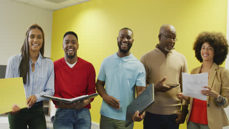 Portrait-of-diverse-male-and-female-business-colleagues-smiling-in-office