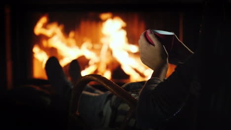 relaxing with a cup of tea by the fireplace