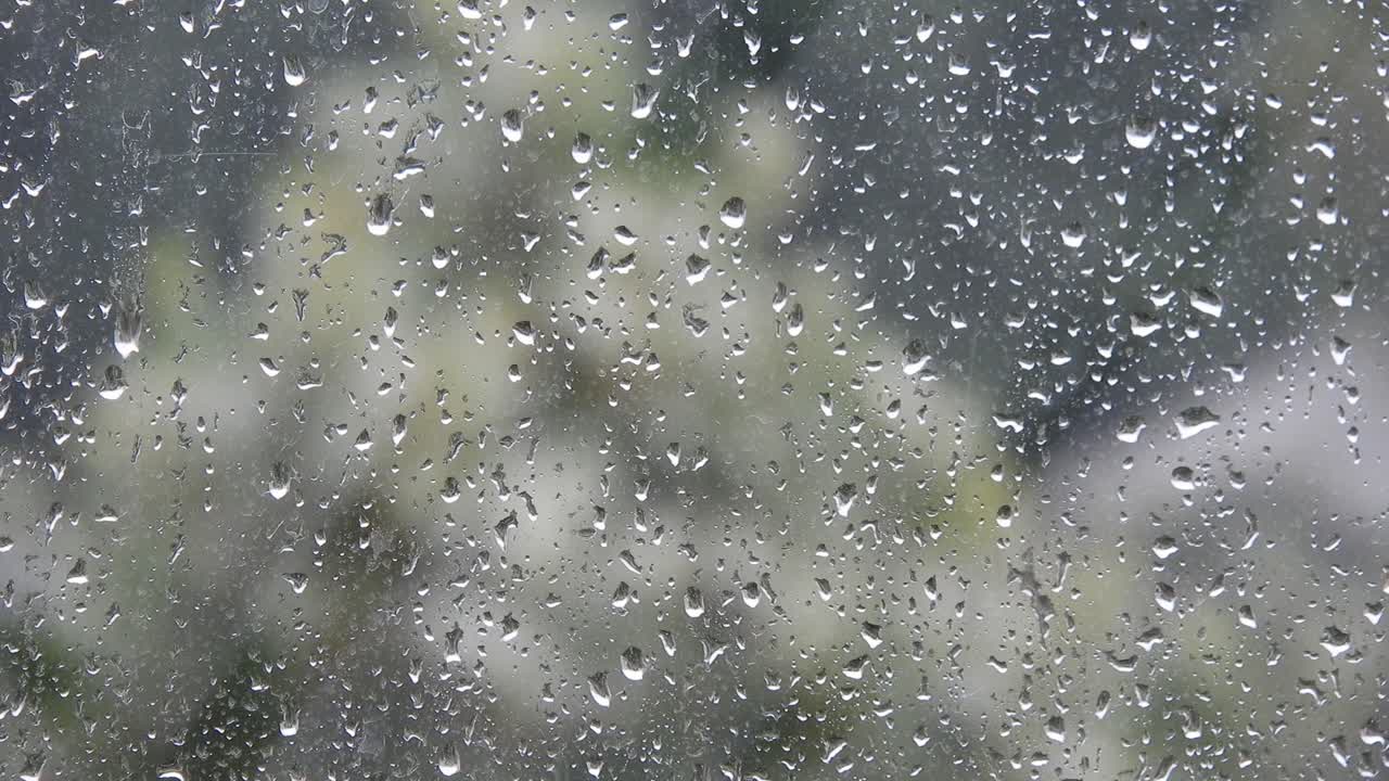 Rainy weather outside the window. Close up of a window with rain drops falling down