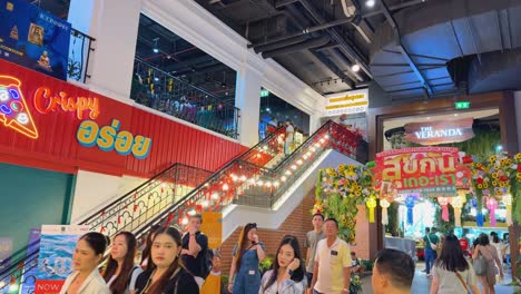 crowds gather at a vibrant mall entrance