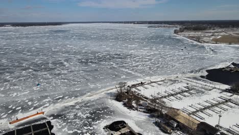 drone pushing forward to follow yachts racing across the ice