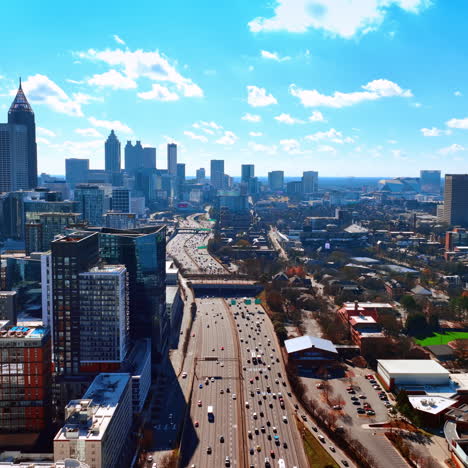 wide multi-lane road going along atlanta downtown. scenic view of american metropolis on sunny day from top.