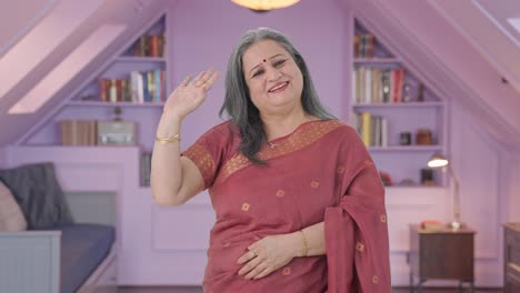 Happy-Indian-old-woman-waving-and-saying-Hello