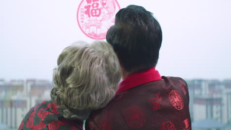 Happy-Couple,-Grandparents-Are-Cuddling,-Smiling-And-Talking-While-Sitting-Together