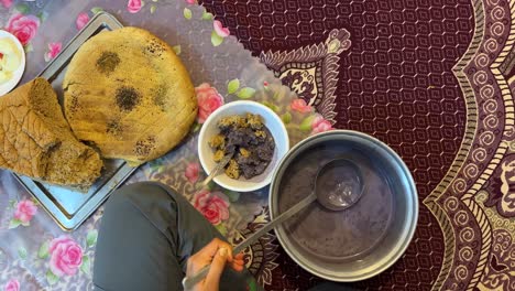 serving traditional local food persian cuisine iranian local people eat delicious qurut kashk the dairy base food with fried eggplant and tomato soak dry bread in bowl dinner time in iran countryside