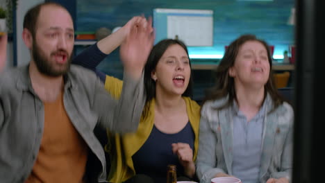 multiracial cheerful friends watching football on television and cheering for goal team