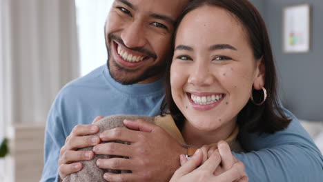 couple smile, hug in living room