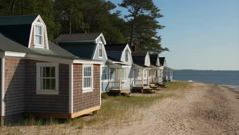row of beach cottages on a sandy shoreline