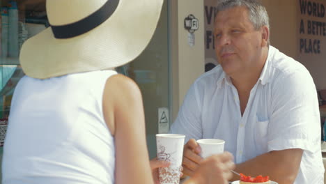 husband and wife eating drinking and talking