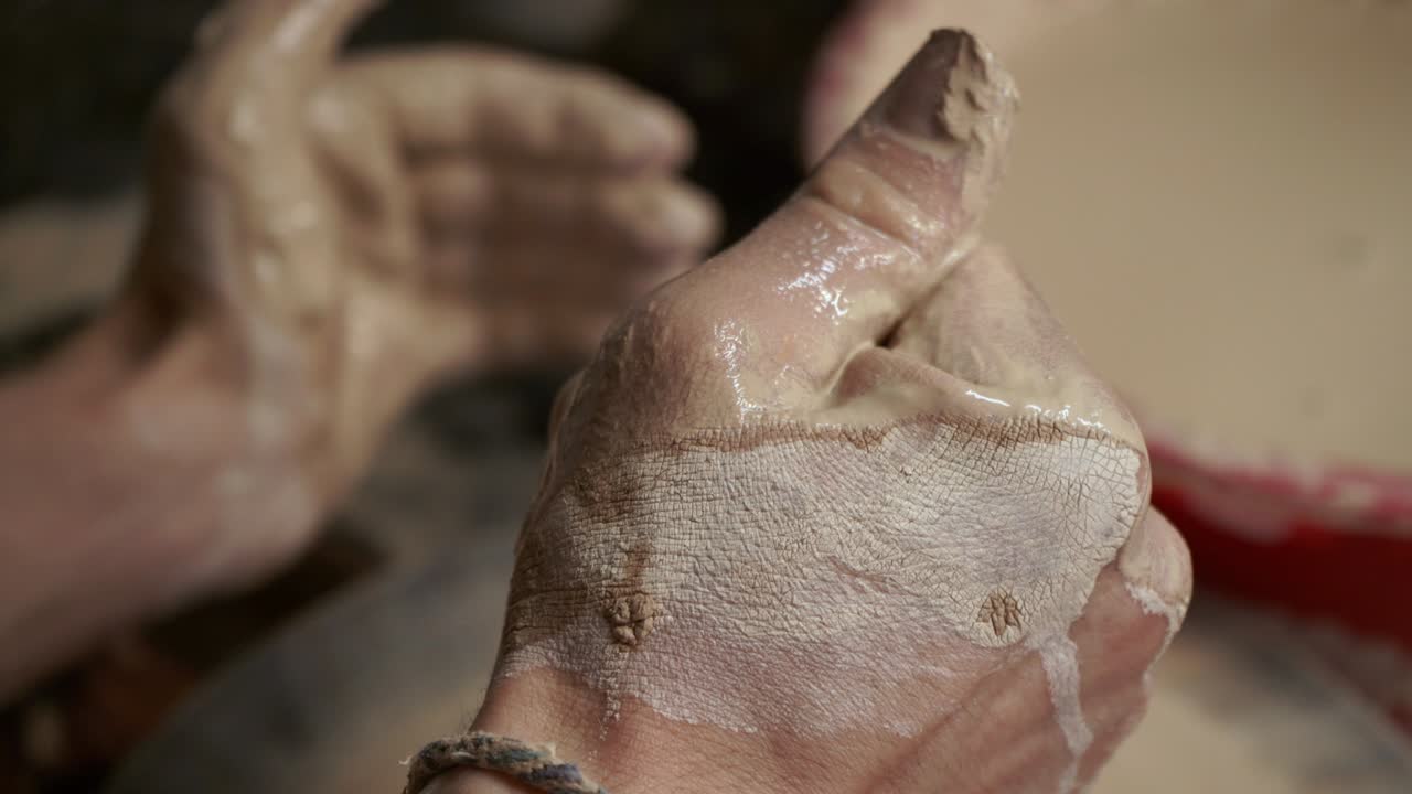 The potter makes a jug of clay. Ceramist. A man makes a vase on a potter's wheel
