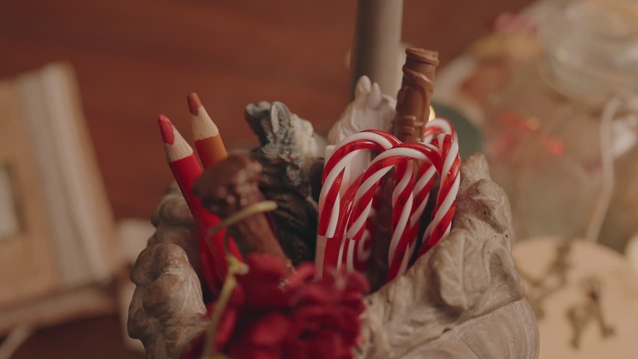 Close up of candy canes and pencils arranged in cozy holiday decor
