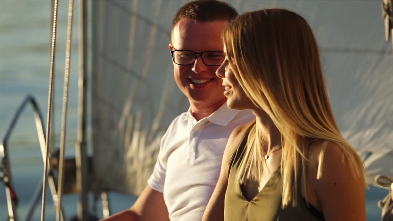 Couple enjoying sunset on a sailboat