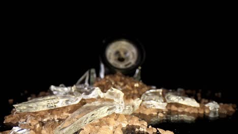 pushing towards a pile of broken glass and sea salt from a broken grinder, macro view of large shards of glass to start and then large mound of salt with the top of the grinder at the end