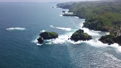 aerial view over the coastline and coral islands in the surf on timang island, indonesia