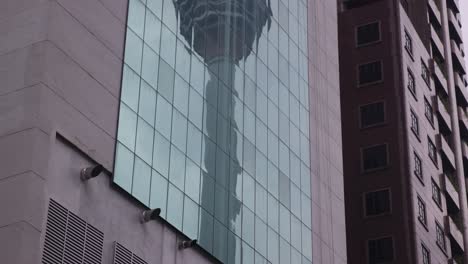 reflection of kl tower in the windows of an office building in kuala lumpur, malaysia