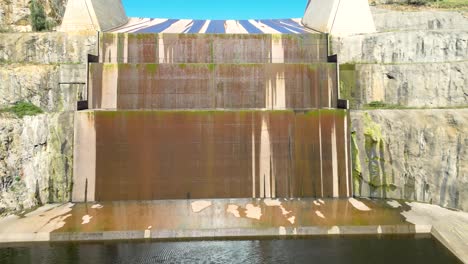 Flying-up-the-spillway-at-Googong-Dam-near-Queanbeyan-in-New-South-Wales,-Australia-on-a-sunny-Summer-day