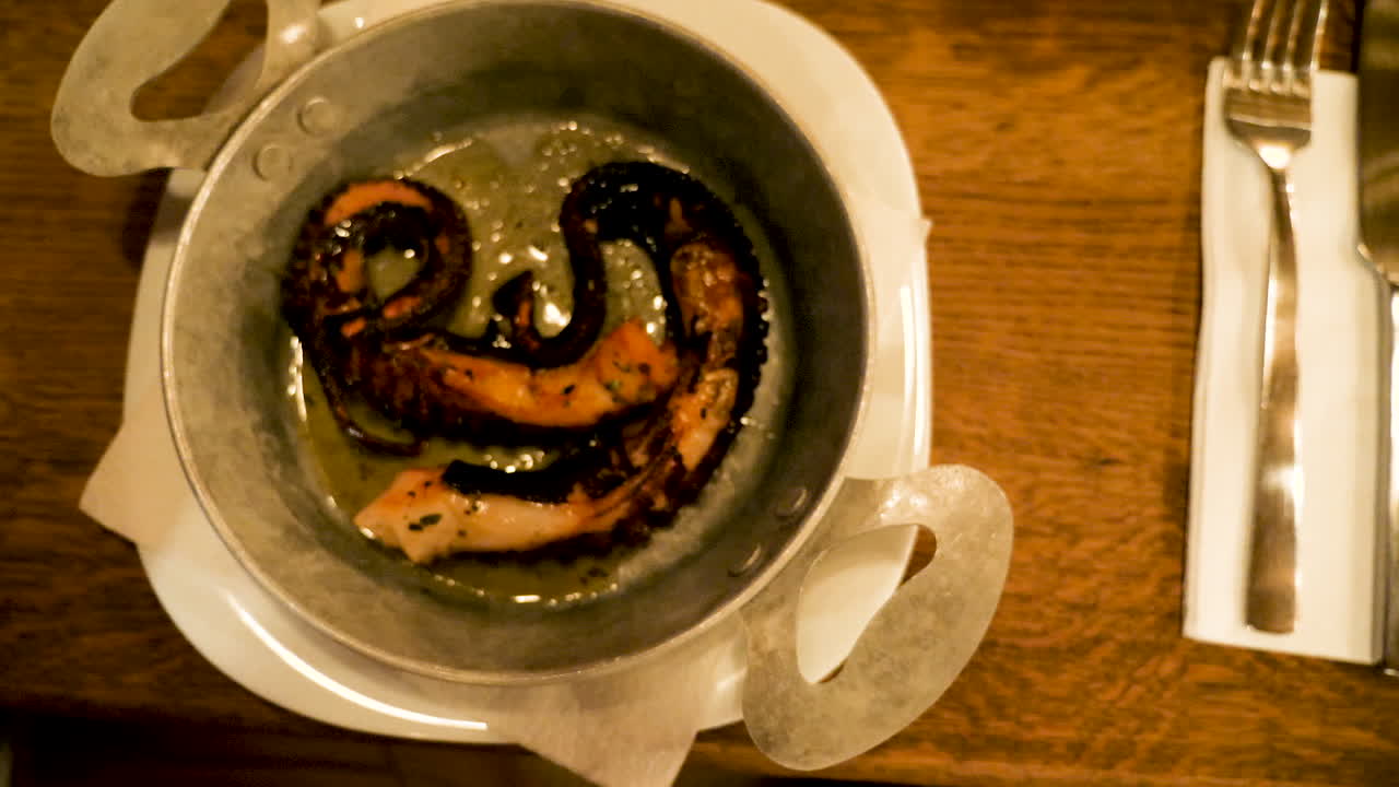 Top view zoom in on gourmet plate with fried octopus