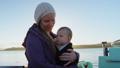 mother with her baby travelling on motor boat 4k