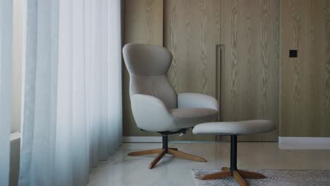 armchair with stool by the window at the corner of bedroom