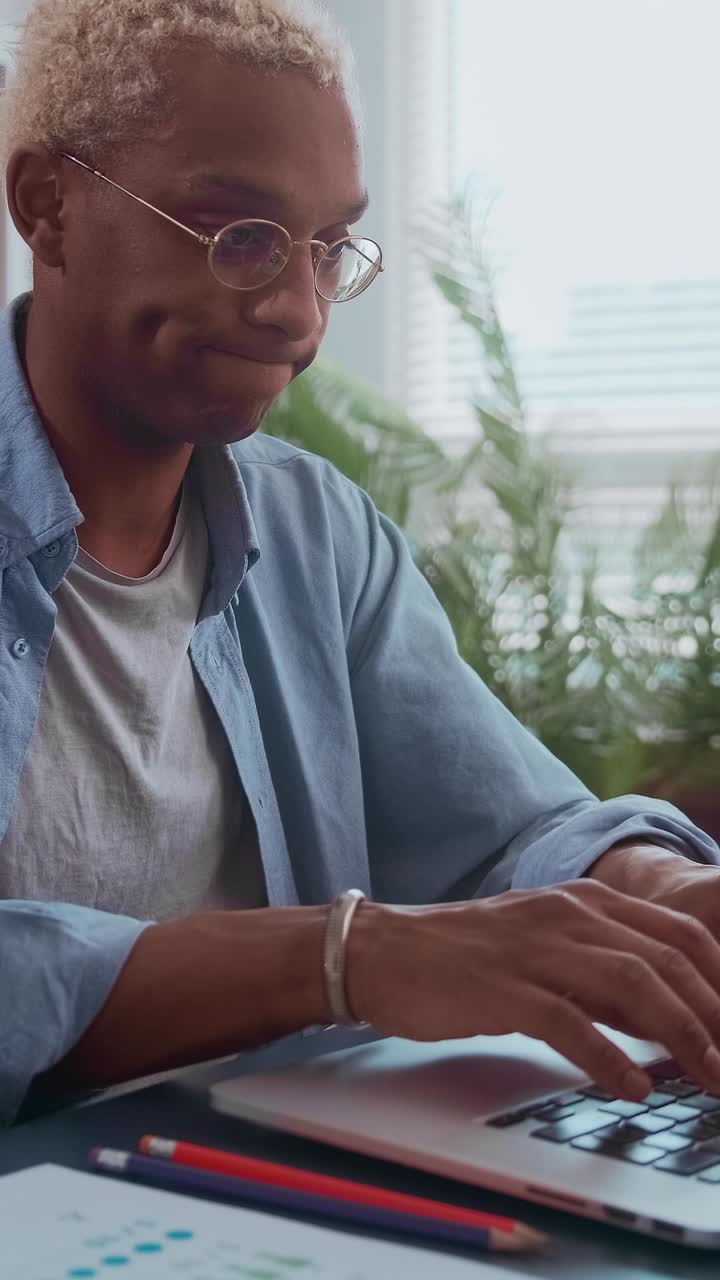 Young african american person focused on work at home desk