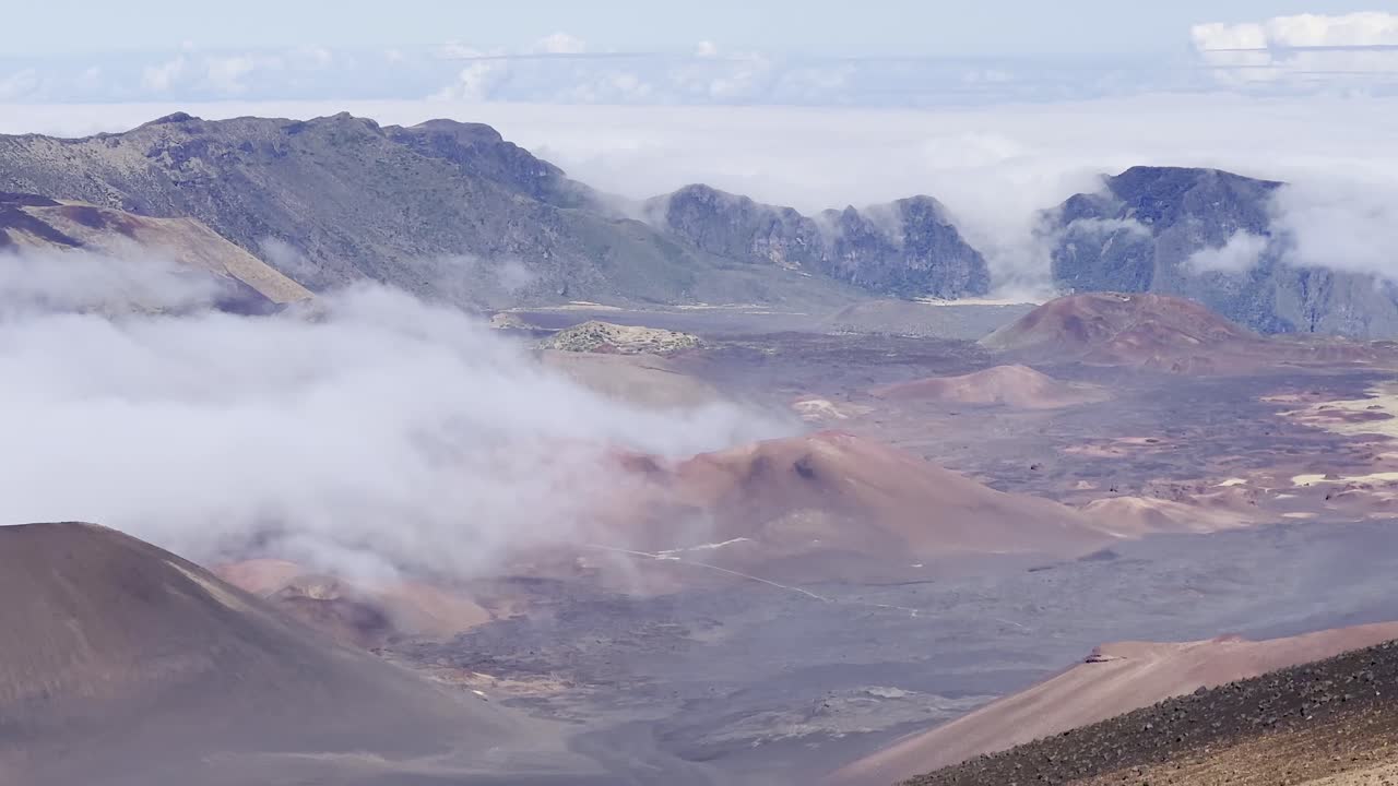 Cinematic panning shot of the volcanic crater from the Sliding Sands trail at the summit of Haleakala in Maui, Hawai'i