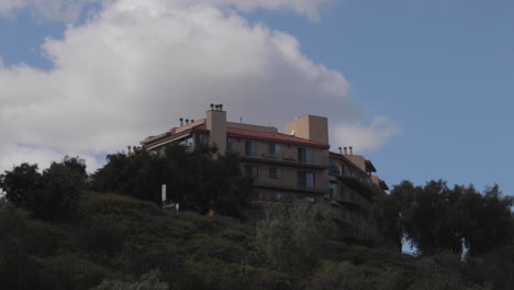 building on a hilltop with airplane