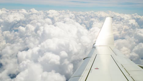 Right-Wing-Of-Plane-On-Blue-Sky-With-cumulus-clouds-background