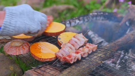 pouring oil over the food being barbecued on the floor