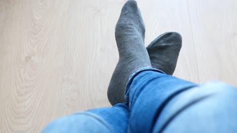 relaxed feet in gray socks and jeans