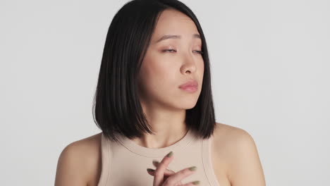 asian woman looking nervous on camera.