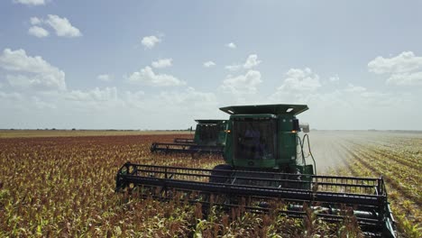 aerial - combine harvester cultivating land, agriculture field, mexico, spinning shot