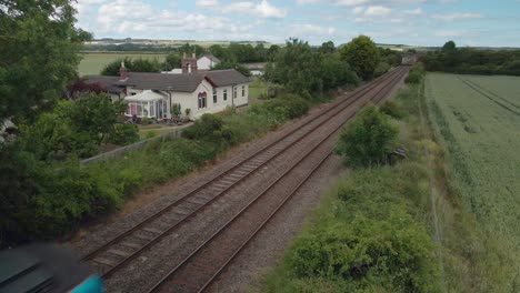 aerial view of a train passing on tracks in the countryside in england