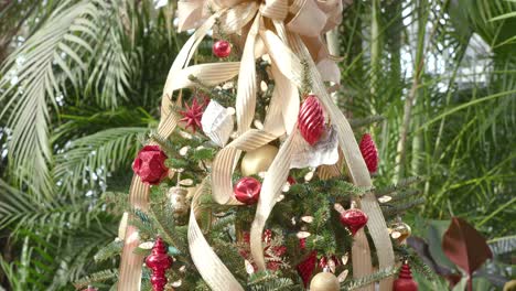 beautifully decorated christmas tree with bow and ornaments