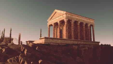 ancient greek temple ruins on a hilltop at sunset