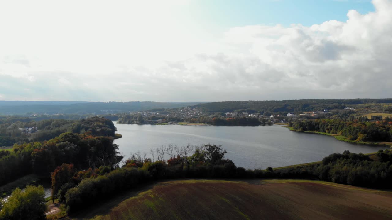 Aerial pan shot meadow and lake in Kolbudy, pomeranian district in Poland