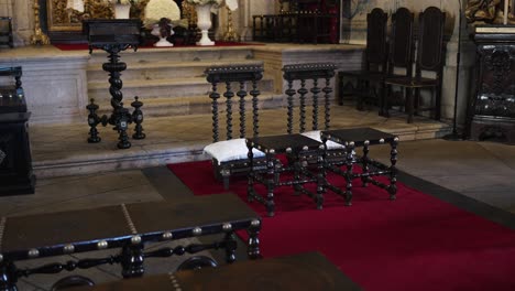 prayer chairs and kneelers set for wedding ceremony in ornate church