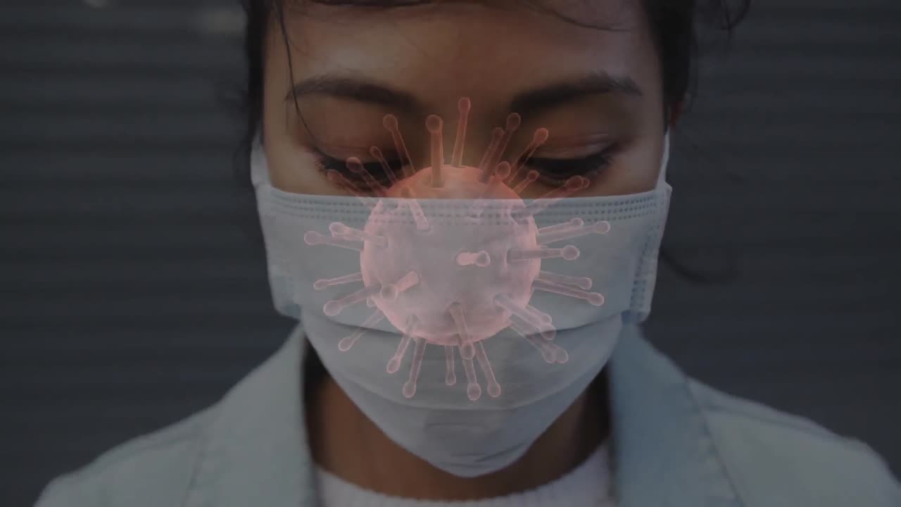 Animation of covid 19 cells moving over woman in face mask
