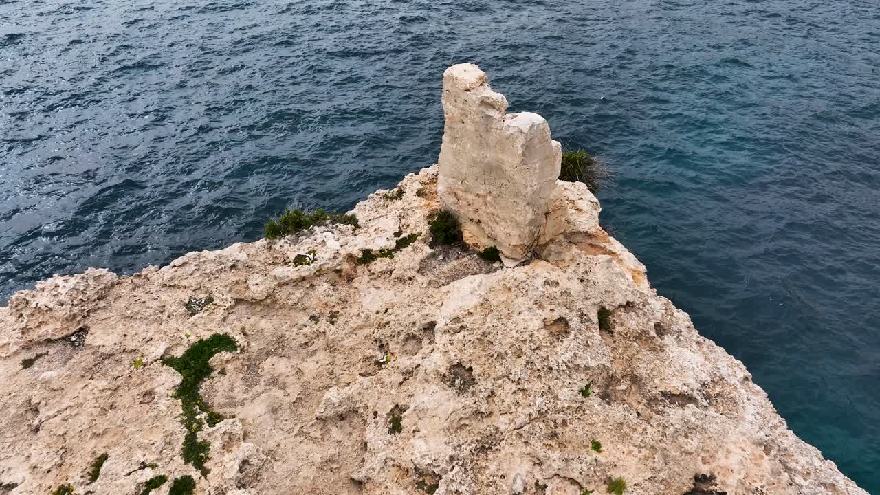 Drone footage reveals a vehicle parked on Ras Tanit’s windswept headland, offering breathtaking views of limestone formations, crashing waves, and Malta’s remote northern coast.