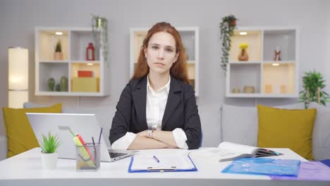 Home-office-worker-woman-looking-dull-at-camera.