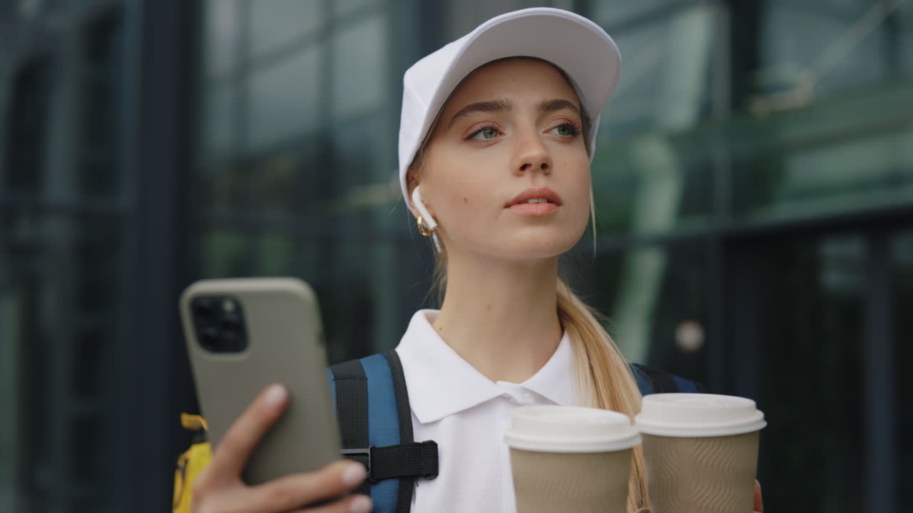 Young Woman with Coffee and Phone Outside