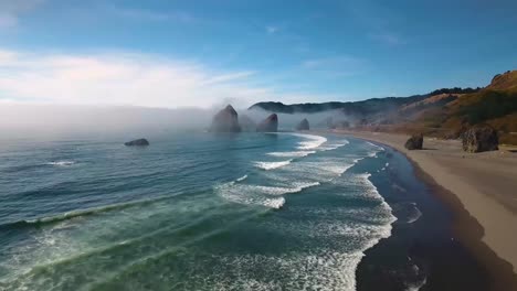 aerial: push in towards oregon's rock formations sitting within the pacific ocean