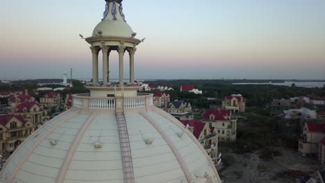 Drone-pilot-orbits-camera-around-himself-in-top-of-domed-building