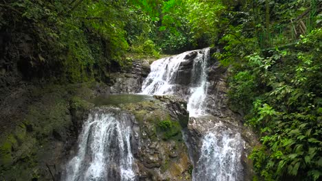 a beautiful waterfall surrounded by lush vegetation